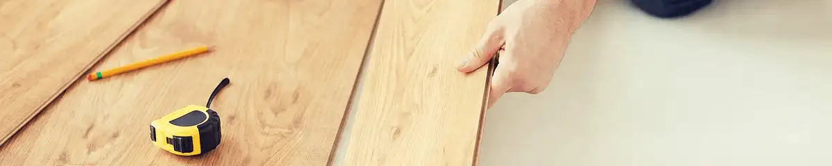 A professional installing wood flooring in Boulder, CO