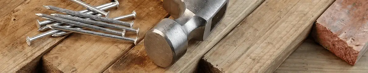 Hammer and nails on hardwood flooring boards in Boulder, CO