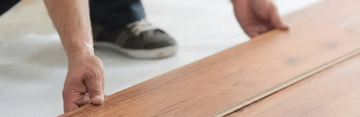 A professional installing laminate flooring in Boulder, CO